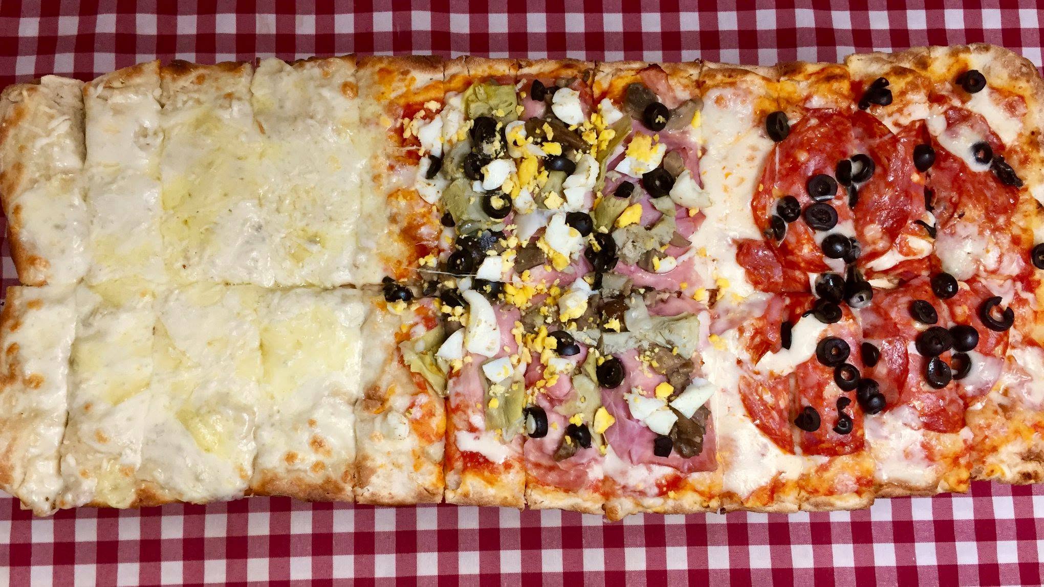 Roman pizza al taglio at Sora Lella, laid out in the colours of the Italian flag — Rua de São Bento 99, Lisbon